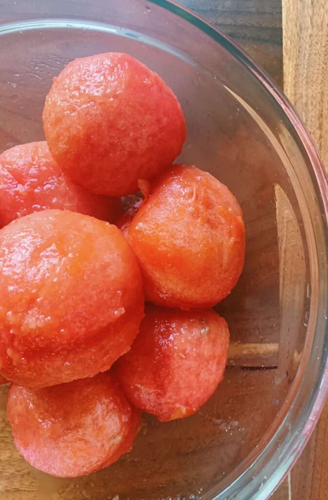 blanched and peeled tomatoes in a glass bowl 
