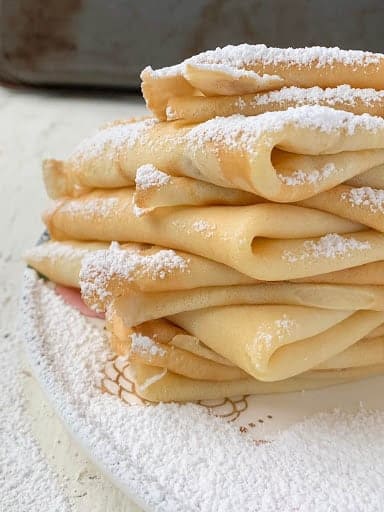 folded crepes stacked on top of each other. 