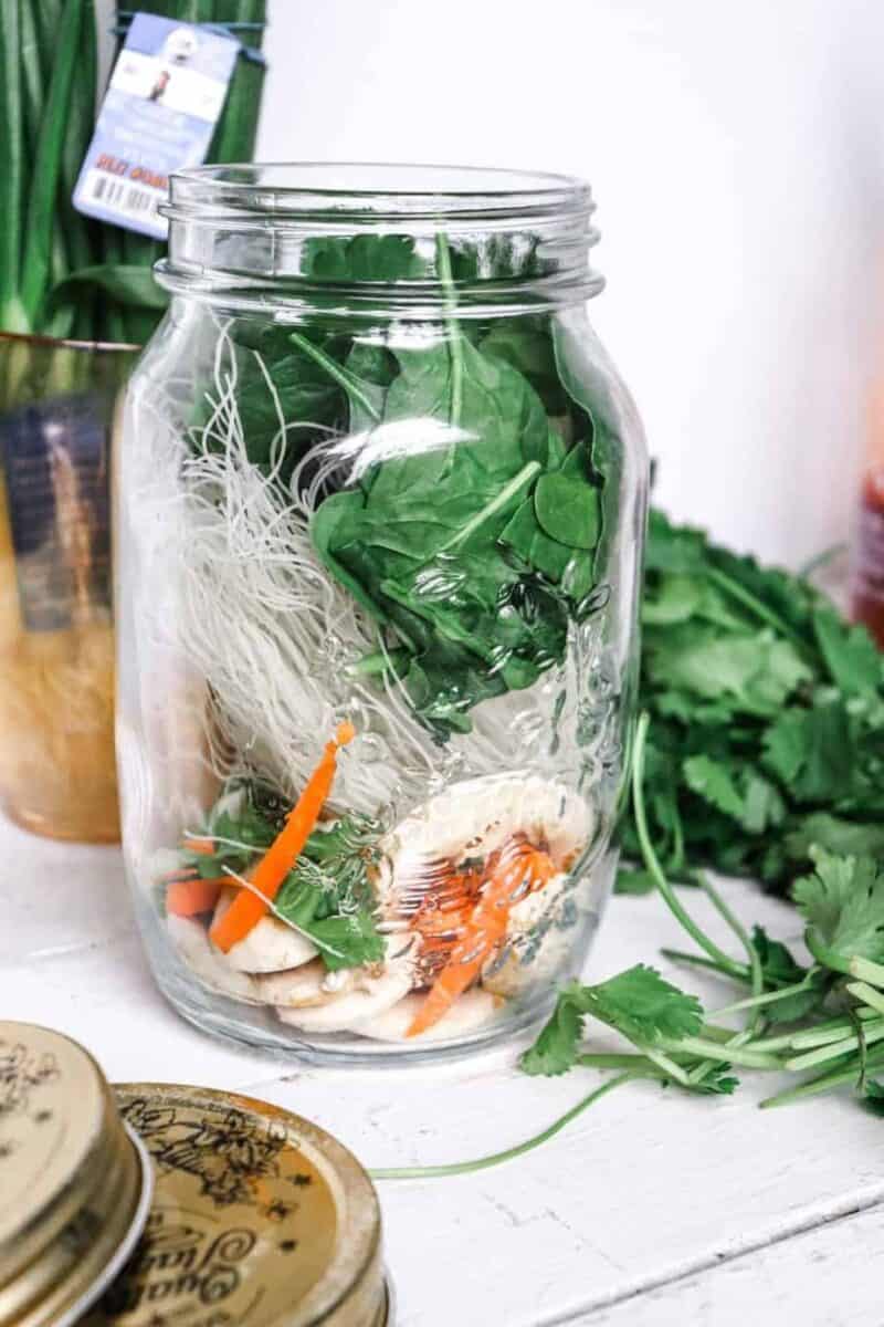 glass jar with noodle cup ingredients added in.
