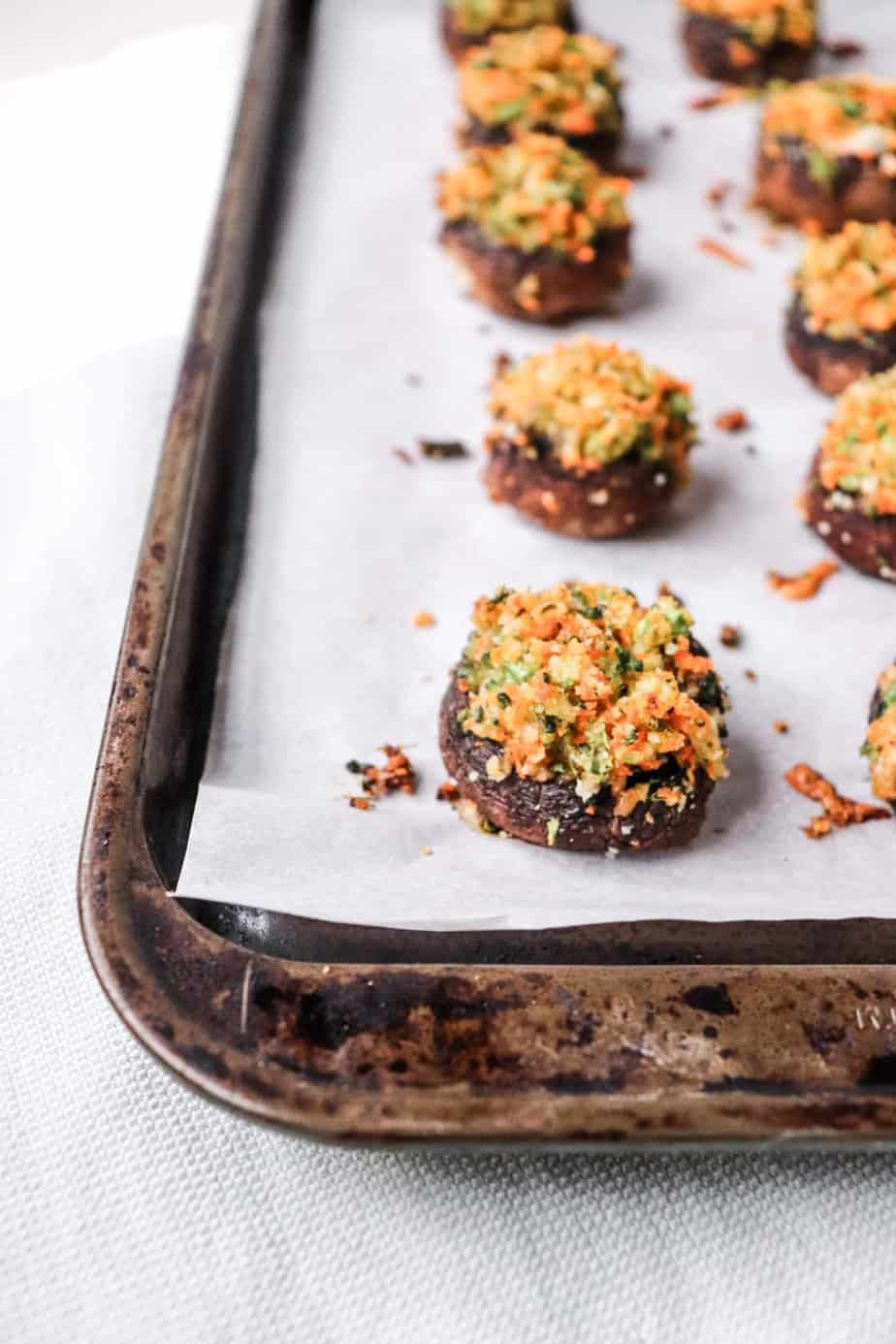 vegetable stuffed mushrooms on a baking sheet.