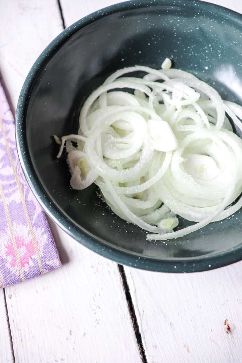 salted onions in a green bowl.