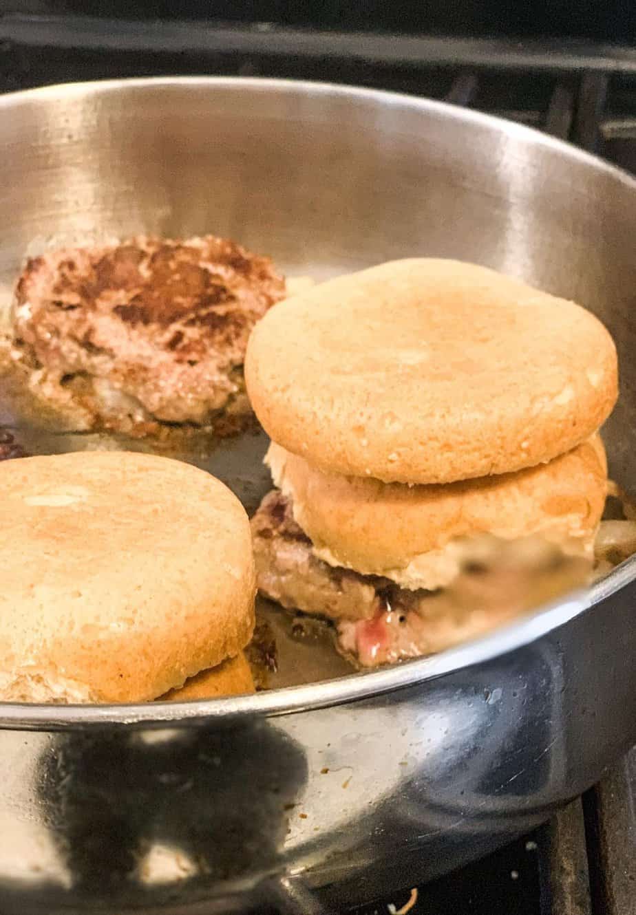 steamed buns on sliders in pan.