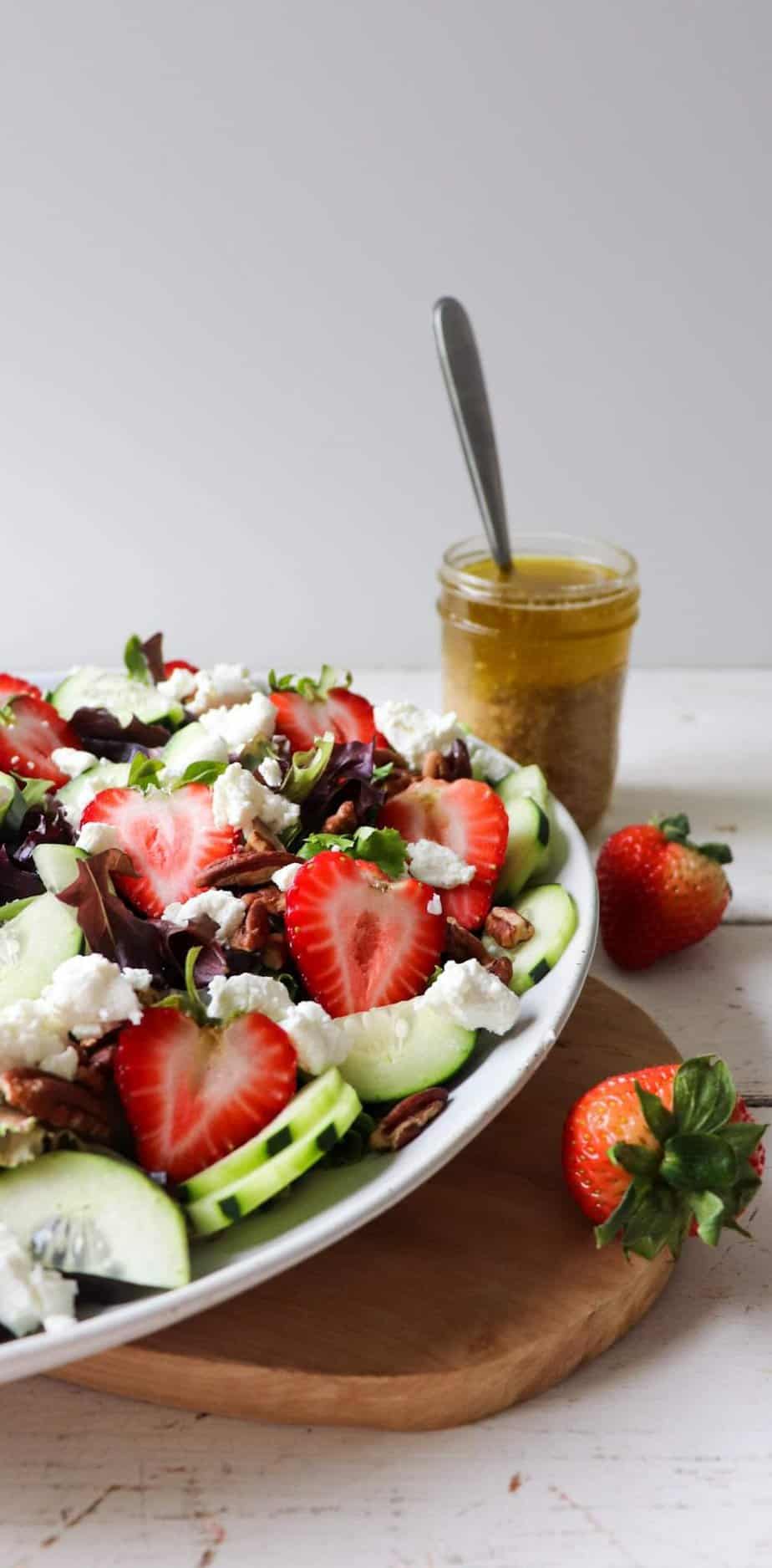 side shot of salad with dressing behind it. 