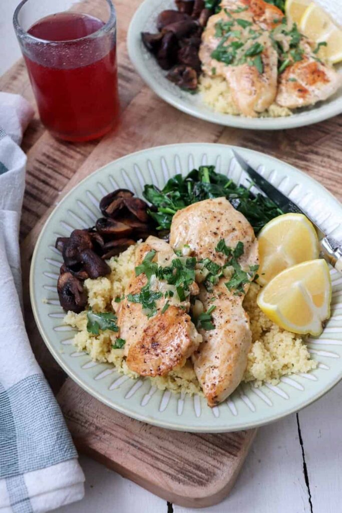 chicken shown plated with sides and drinks.