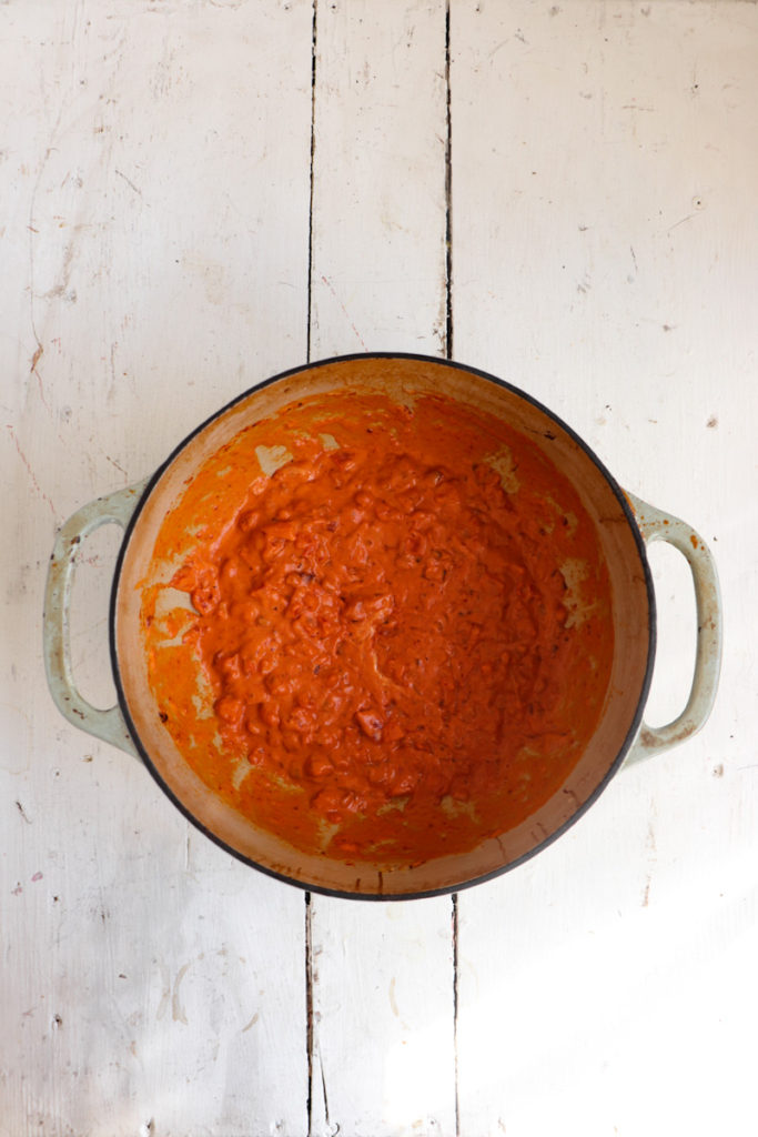 vodka sauce in a large pot on a white background