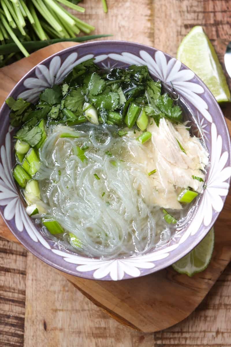 glass noodle soup in a purple bowl on a wooden background