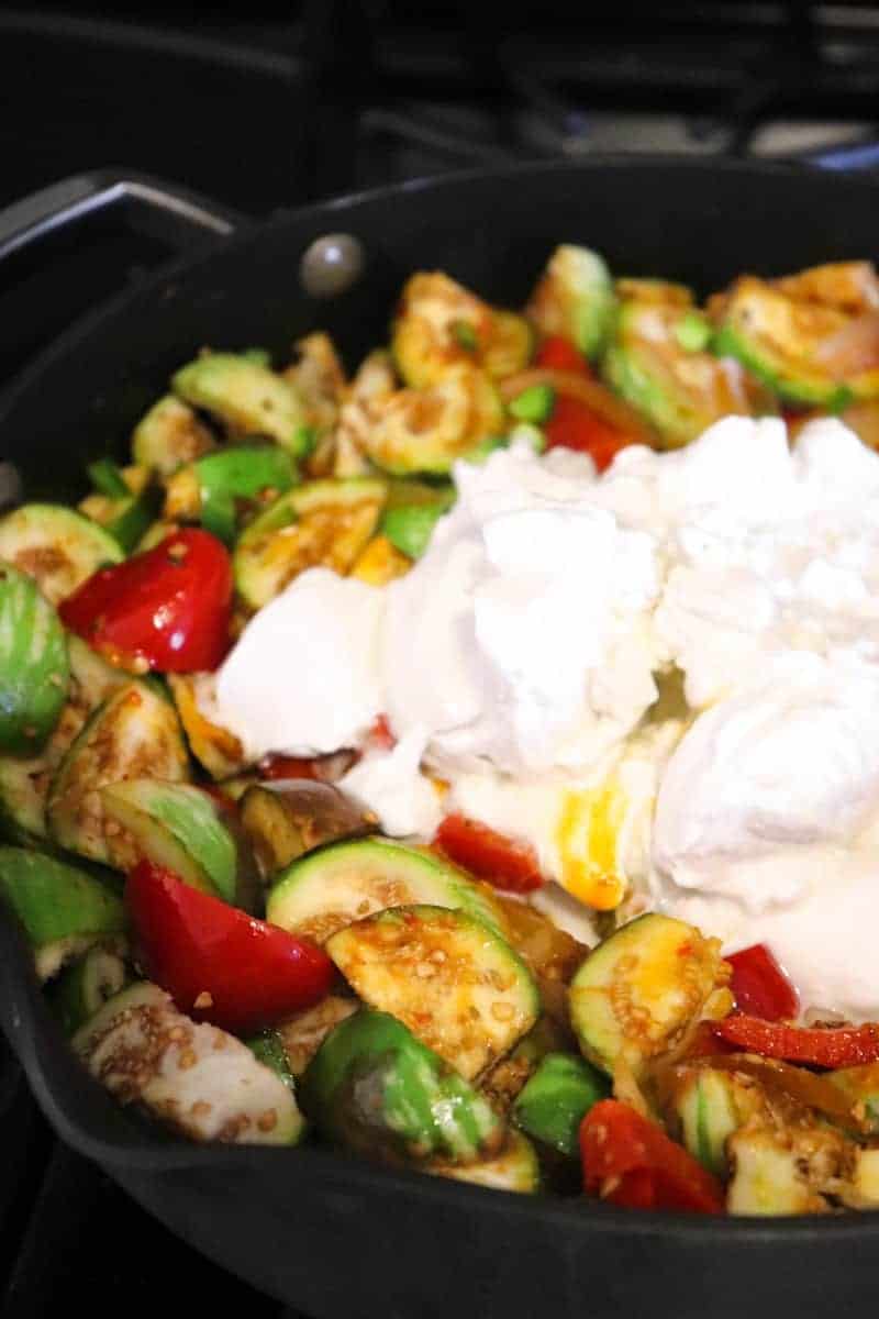 coconut milk poured into stir fried vegetables.