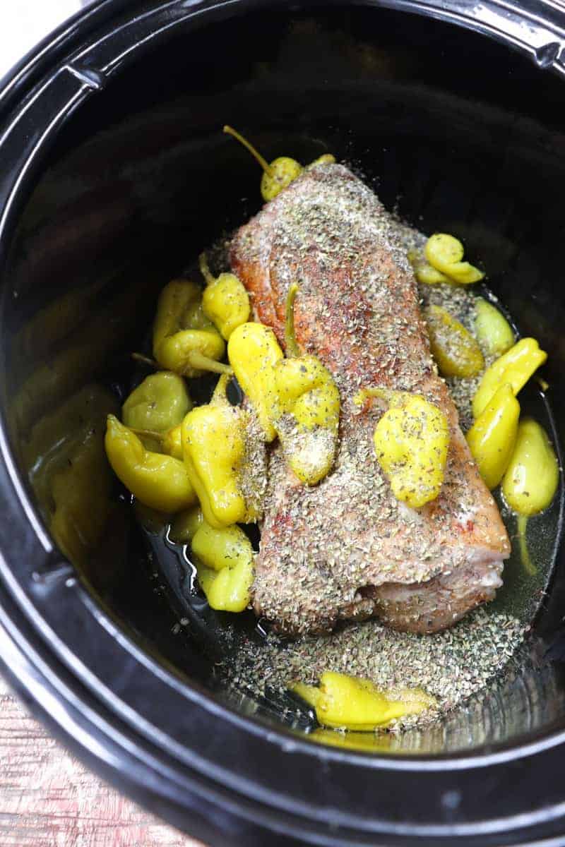 pork, spices, and pepperoncini added to crock pot.  