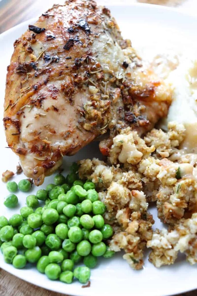 baked chicken with peas, stuffing, mashed potatoes, and gravy