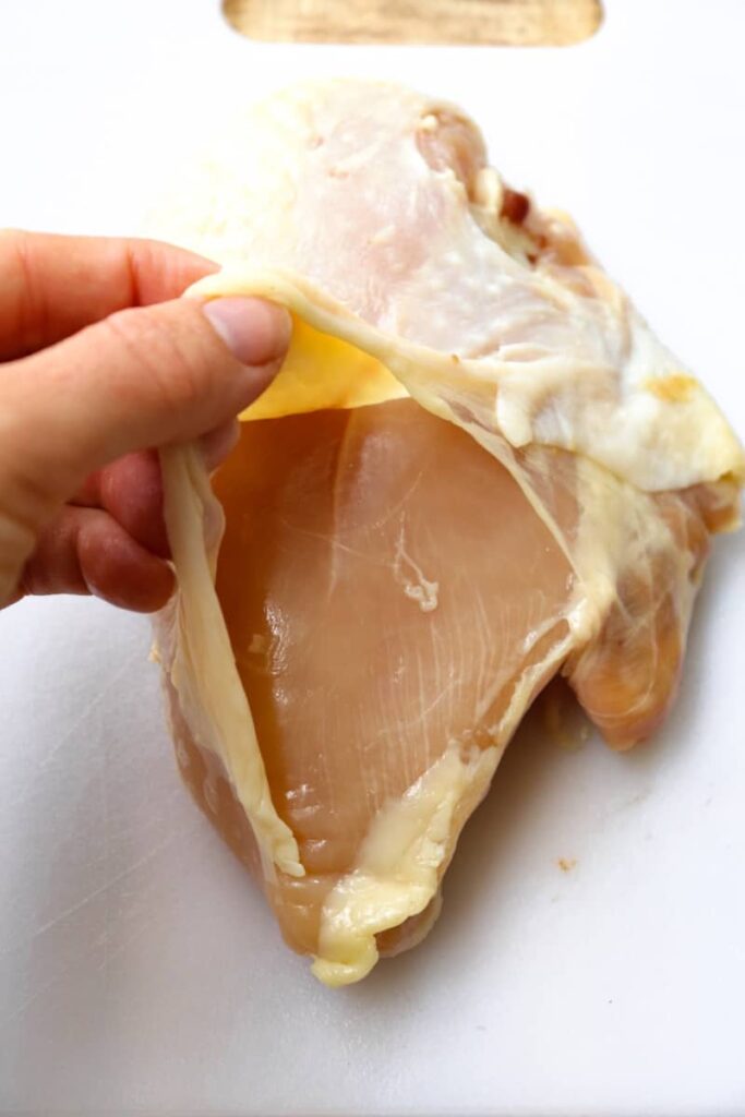one chicken breast with skin pulled back