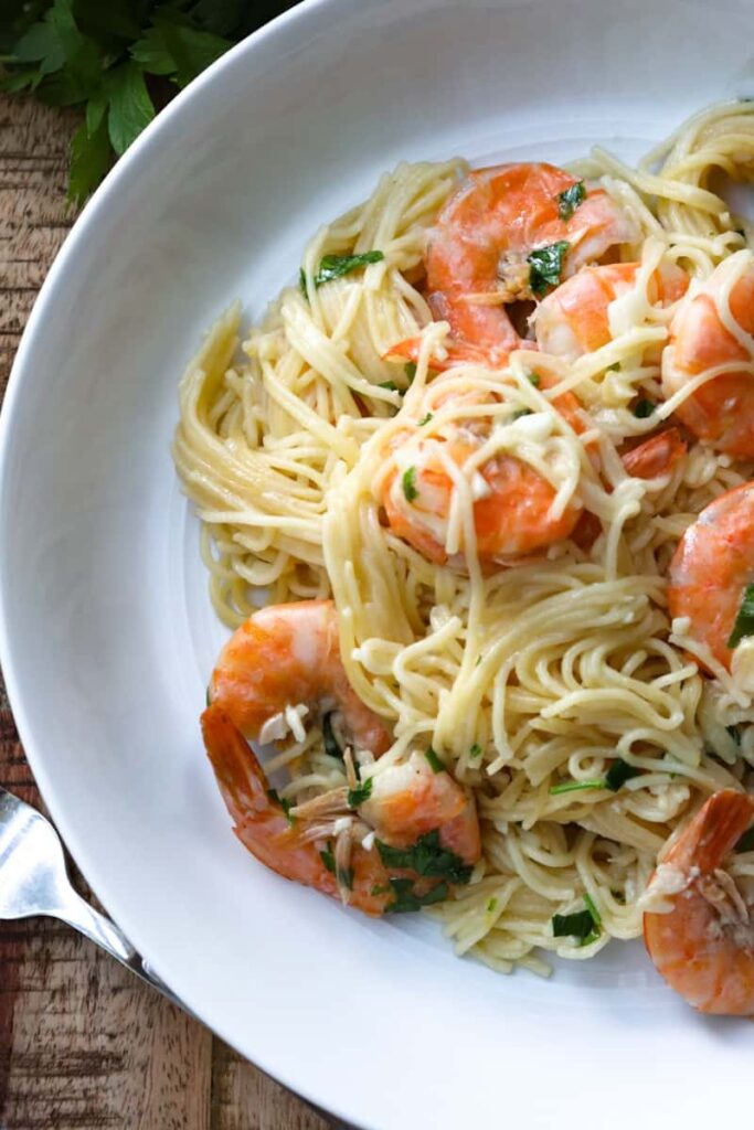 plated scampi with multiple shrimp in pasta on a white plate 