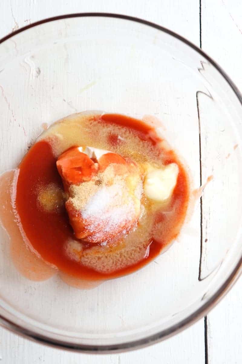 buffalo sauce ingredients unmixed in a clear glass bowl 