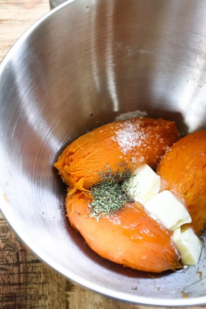 cooked and peeled potatoes in the bowl of the stand mixer along with the rest of the ingredients