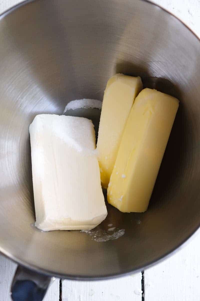 1 block of cream cheese and two sticks of butter in a metal bowl