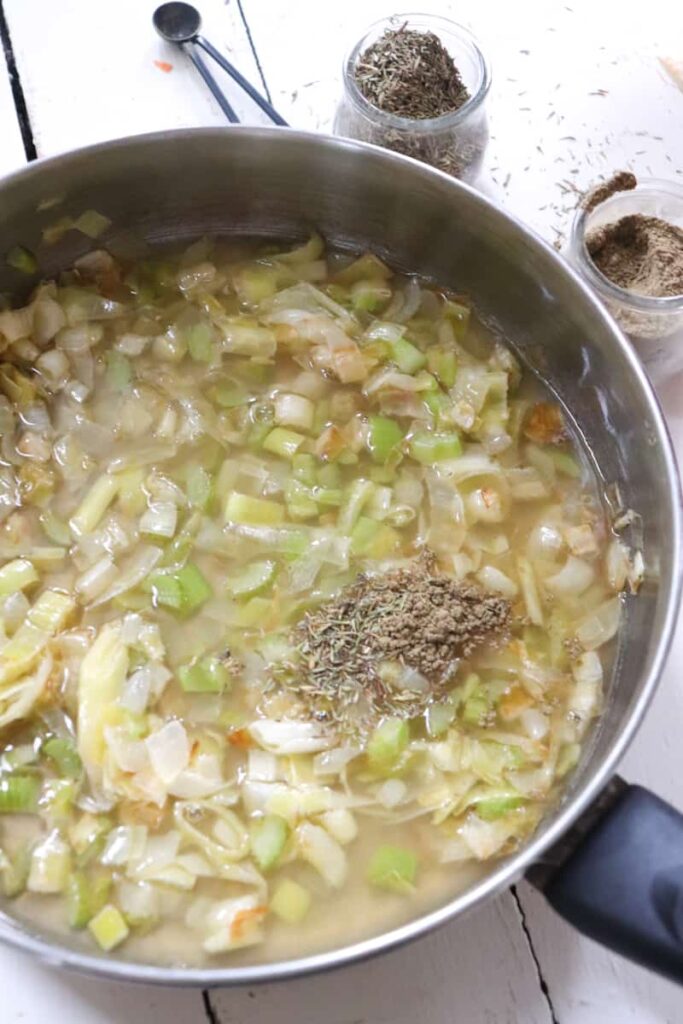 chicken stock added to leeks, onions, celery, along with dried spices 