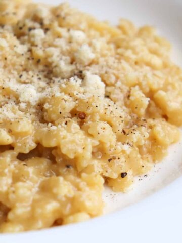 bowl of pastina topped with parmesan cheese.