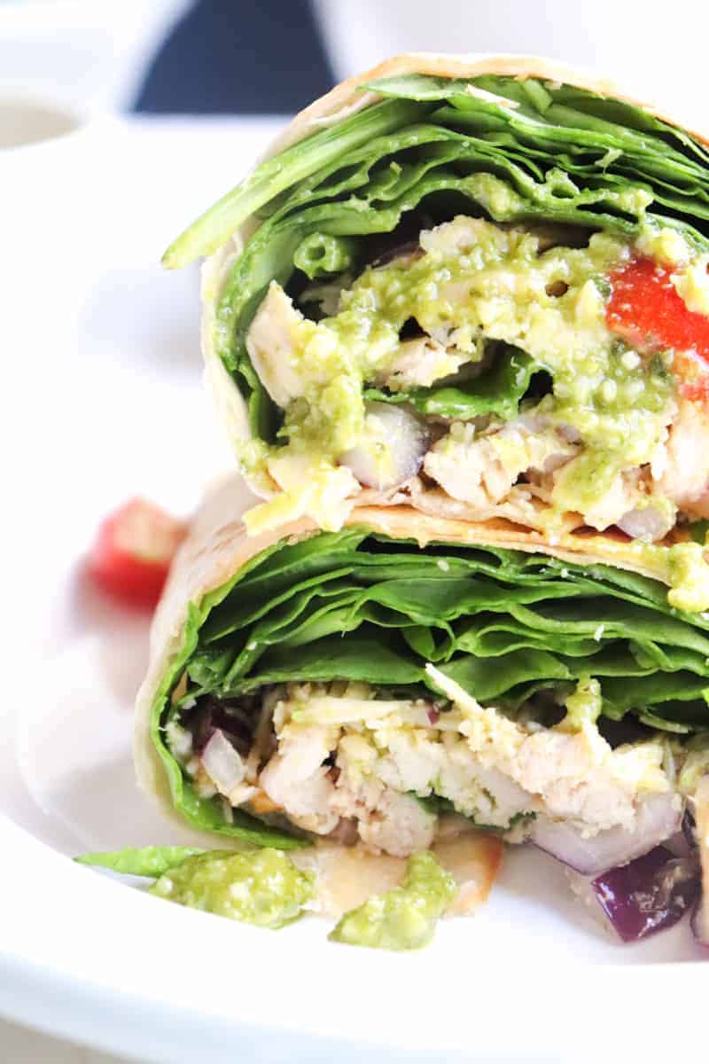 a pestco chicken wrap with spinach cut in half