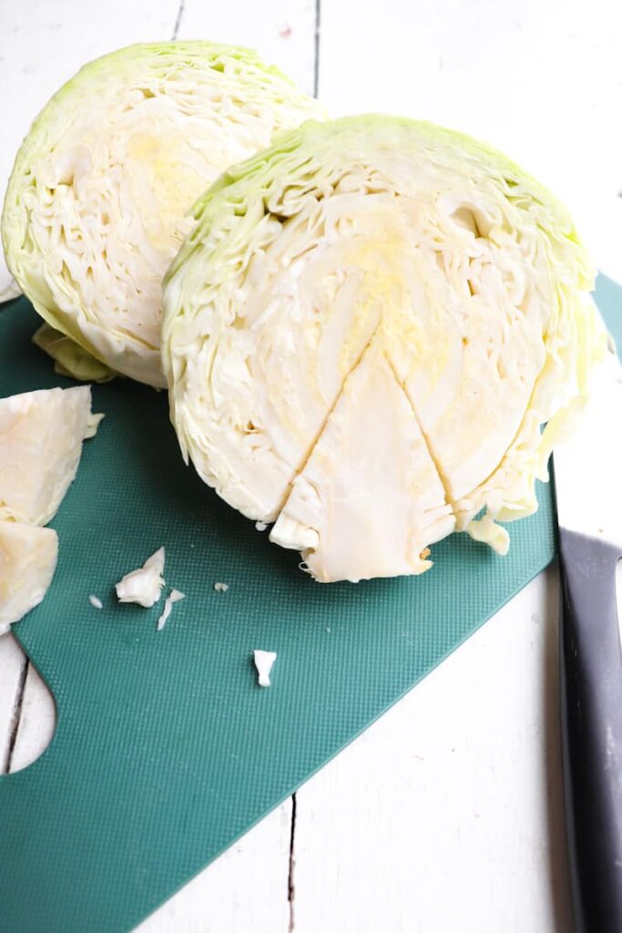 cabbage cut in half and the core outlined