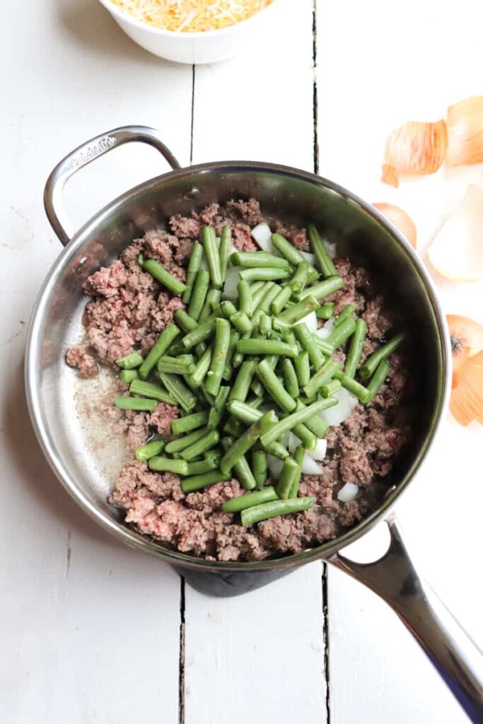 green beans, ground hamburger meat, and onions before being sauteed