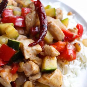 up close kung pao chicken plated with a pepper on top