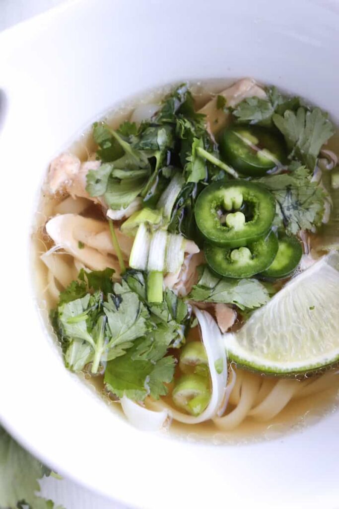 pho topped with herbs and vegetables