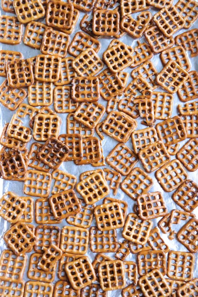 mini pretzels spread on a covered cookie sheet