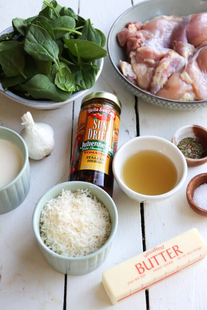 ingredients for slow cooker tuscan chicken on a white background