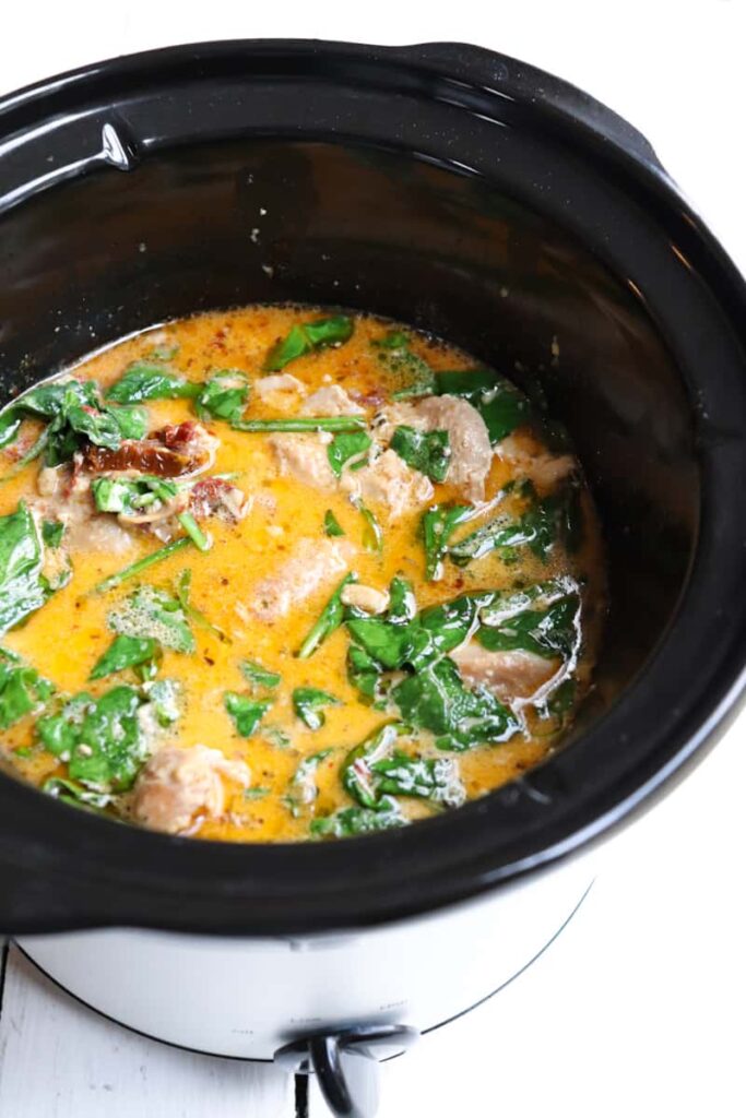 finished slow cooker tuscan chicken thighs in crock pot