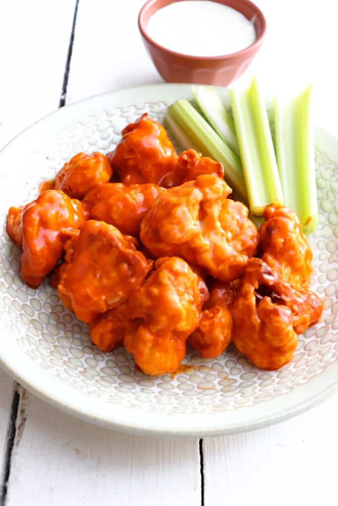 air fryer buffalo wings plated with celery