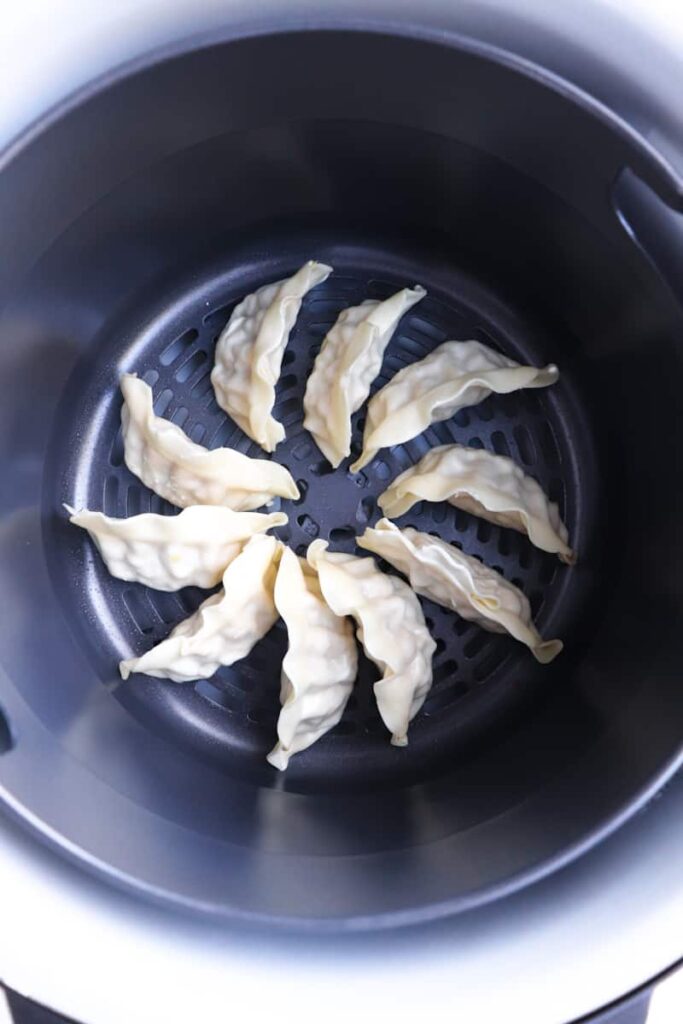 frozen potstickers in a circle in an airfryer basket