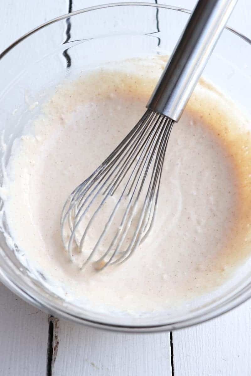batter in a glass bowl with a whisk