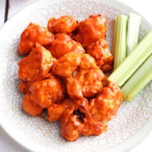 air fryer buffalo wings plated with celery