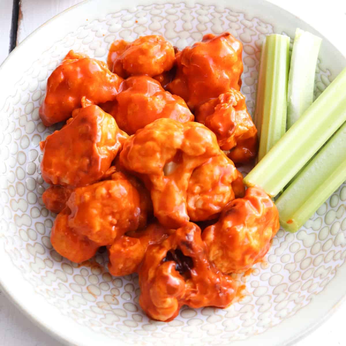 air fryer buffalo wings plated with celery