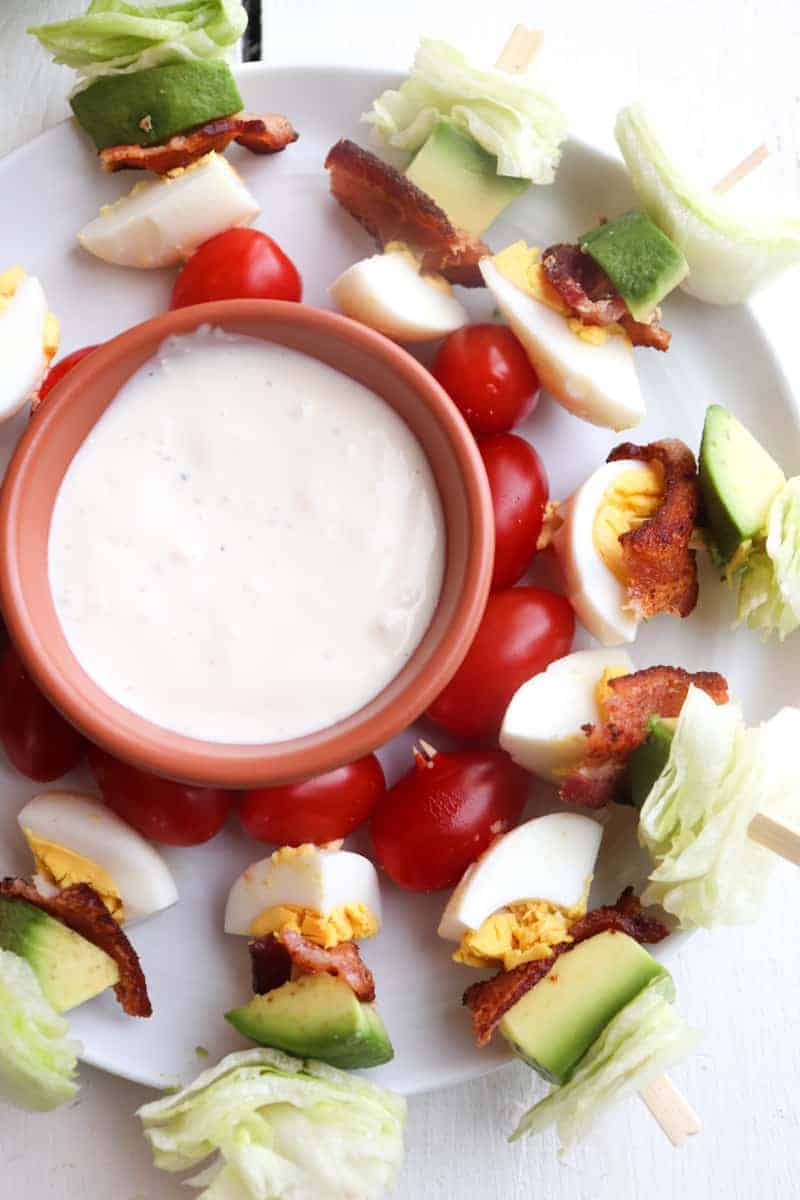 salad kabobs in a circle pattern surrounding blue cheese dressing