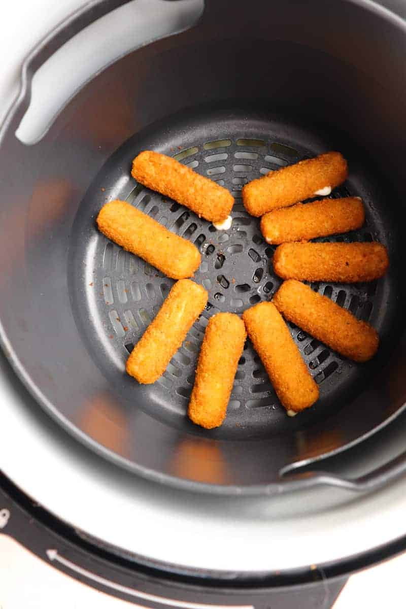 cooked mozzarella sticks in air fryer basket