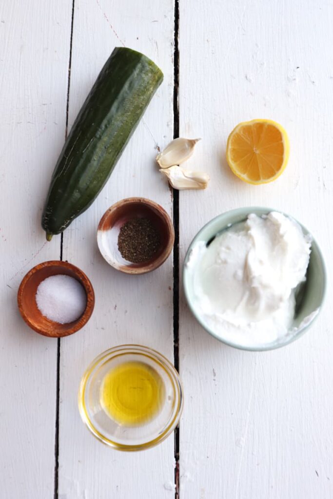 ingredients for garlicky greek yogurt and cucumber sauce on a white background