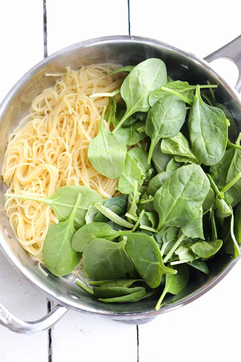 cooked angel hair pasta with baby spinach