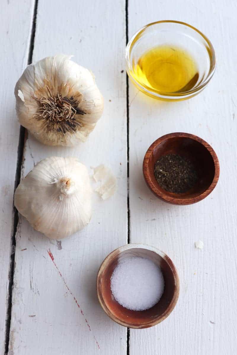 ingredients for air fryer roasted garlic on a white background