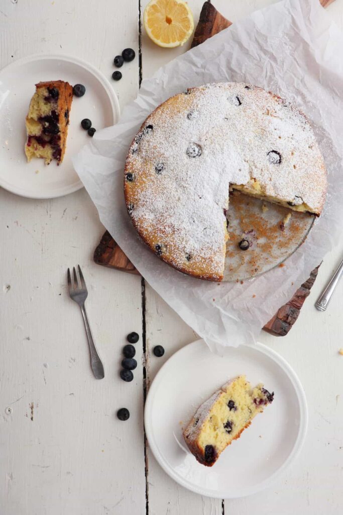 blueberry lemon ricotta cake with two slices cut out
