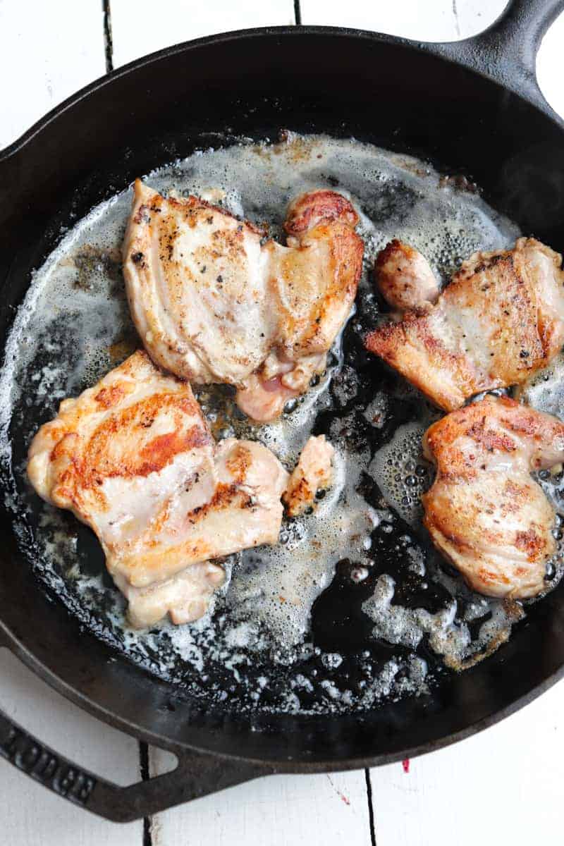 chicken cooking in butter in skillet