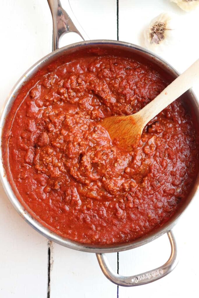 finished meat sauce in a skillet with a spoon