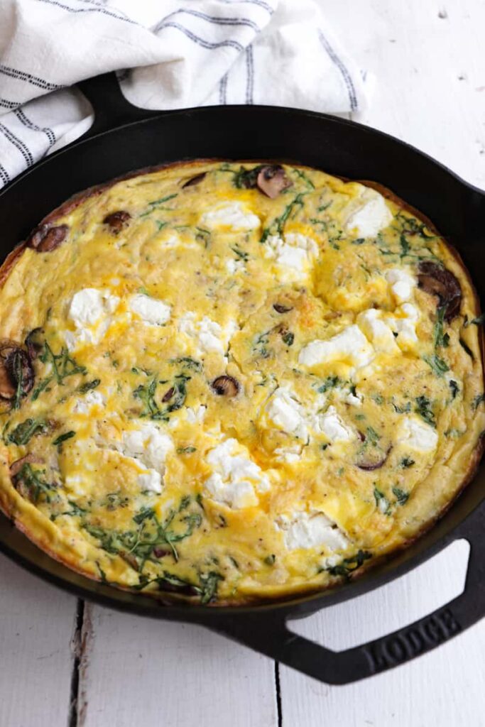 finished goat cheese frittata in cast iron skillet