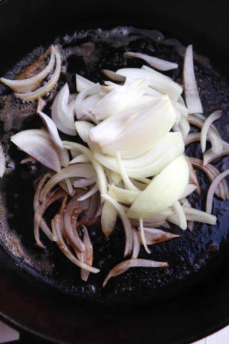 sliced onions in cast iron skillet