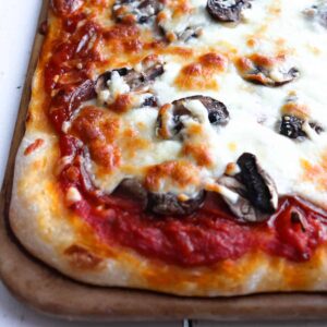 cooked rectangle pizza with pepperoni and mushroom
