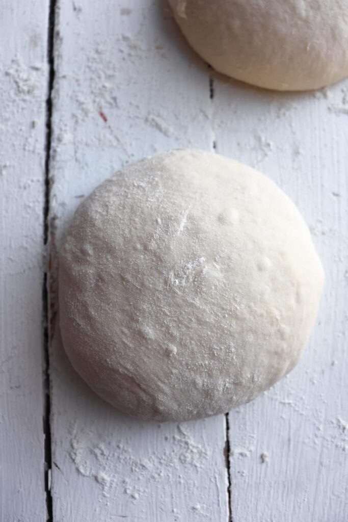 floured sourdough pizza dough ball