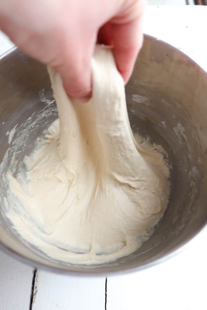 hand pulling dough to stretch and fold
