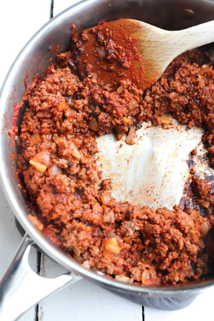 browned venison meat coated tomato paste
