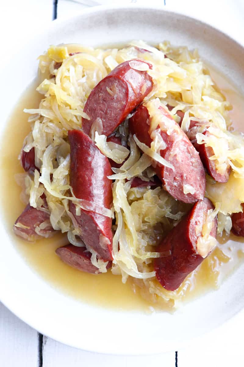 up close of crockpot kielbasa and sauerkraut dish plated.