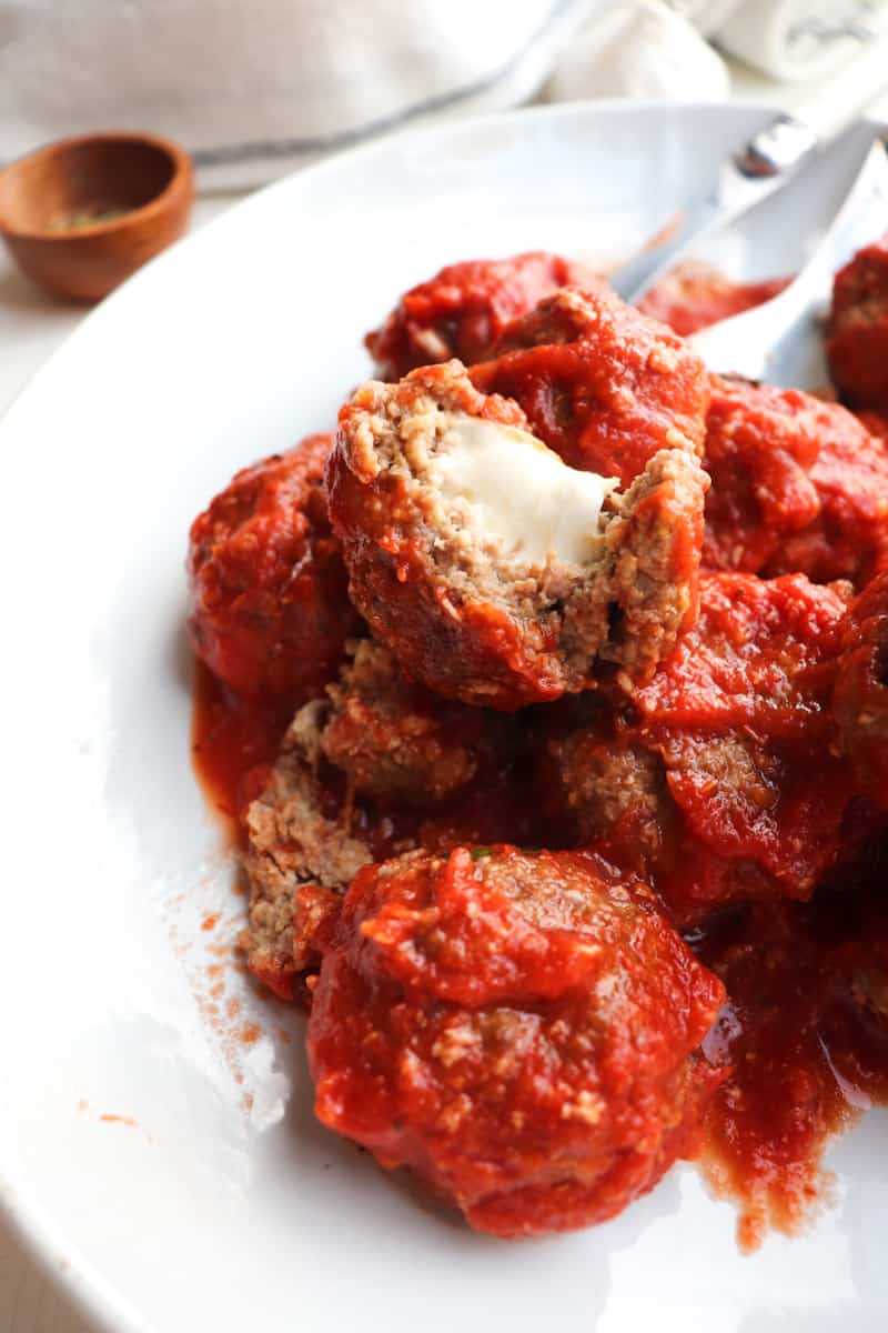 platter of cheese stuffed meatballs with one cute open