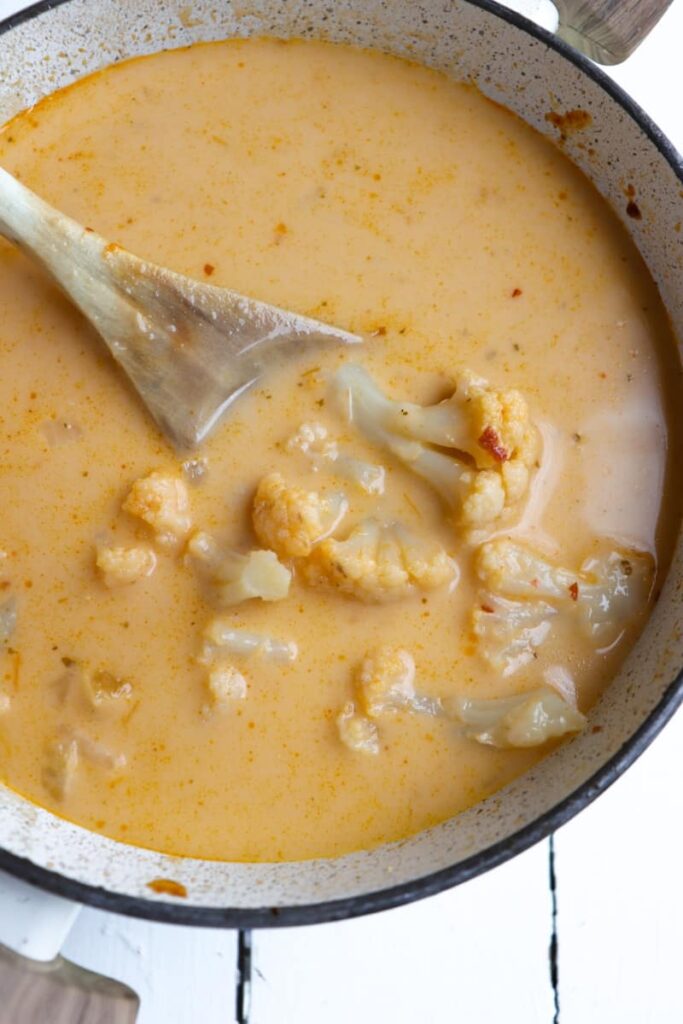finished soup with wooden spoon in pot